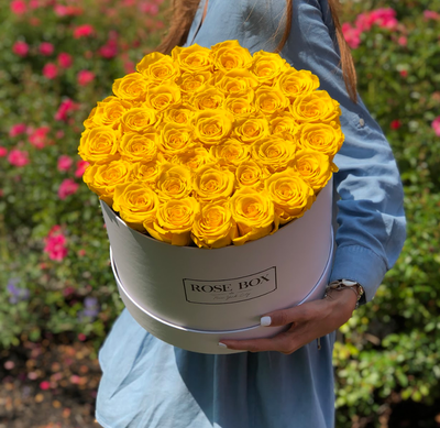 Large Round White Box with Bright Yellow Roses